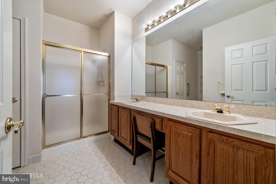 84 Chain Boulevard Bayville, NJ 08721 - Photo 23 of 39 a bathroom with a double vanity sink and mirror
