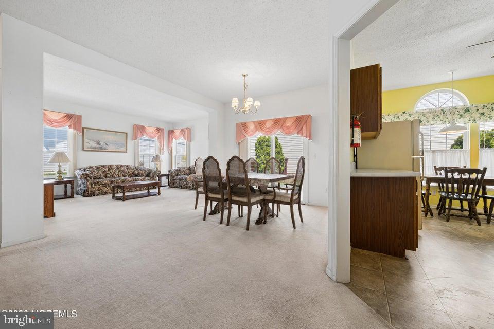 84 Chain Boulevard Bayville, NJ 08721 - Photo 5 of 39 a living room with furniture and a chandelier