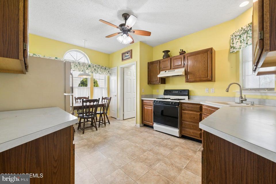 84 Chain Boulevard Bayville, NJ 08721 - Photo 6 of 39 a kitchen with stainless steel appliances a stove a sink and a refrigerator