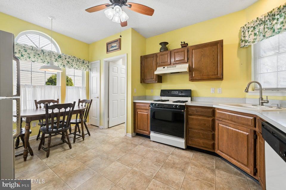 84 Chain Boulevard Bayville, NJ 08721 - Photo 7 of 39 a kitchen with stainless steel appliances a stove a sink a dining table and chairs