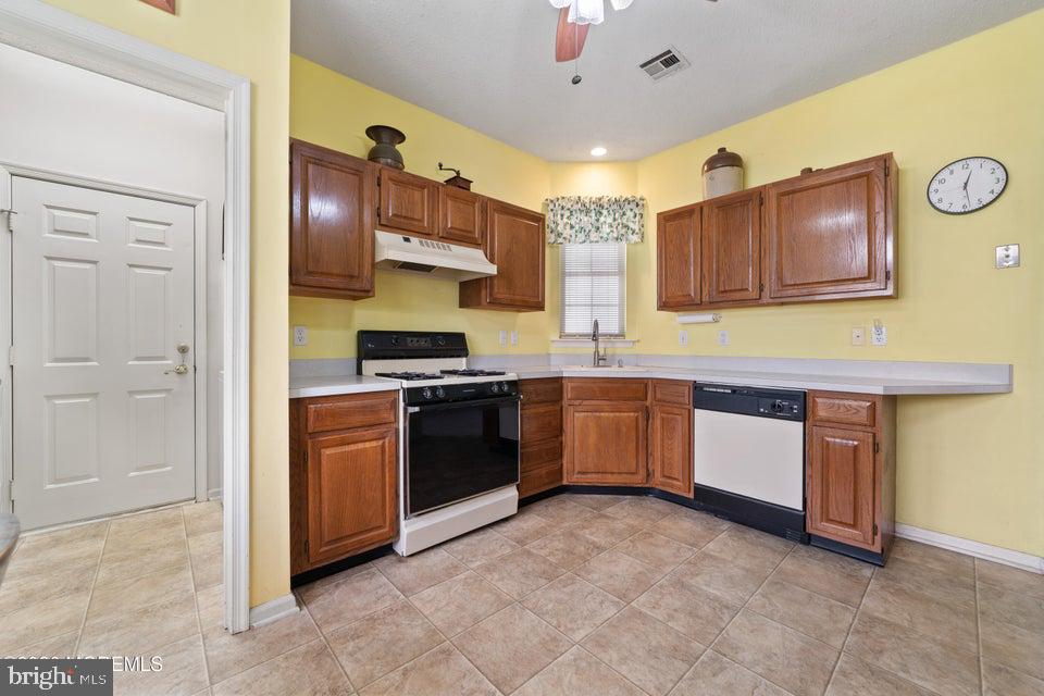 84 Chain Boulevard Bayville, NJ 08721 - Photo 9 of 39 a kitchen with stainless steel appliances granite countertop a stove and a refrigerator
