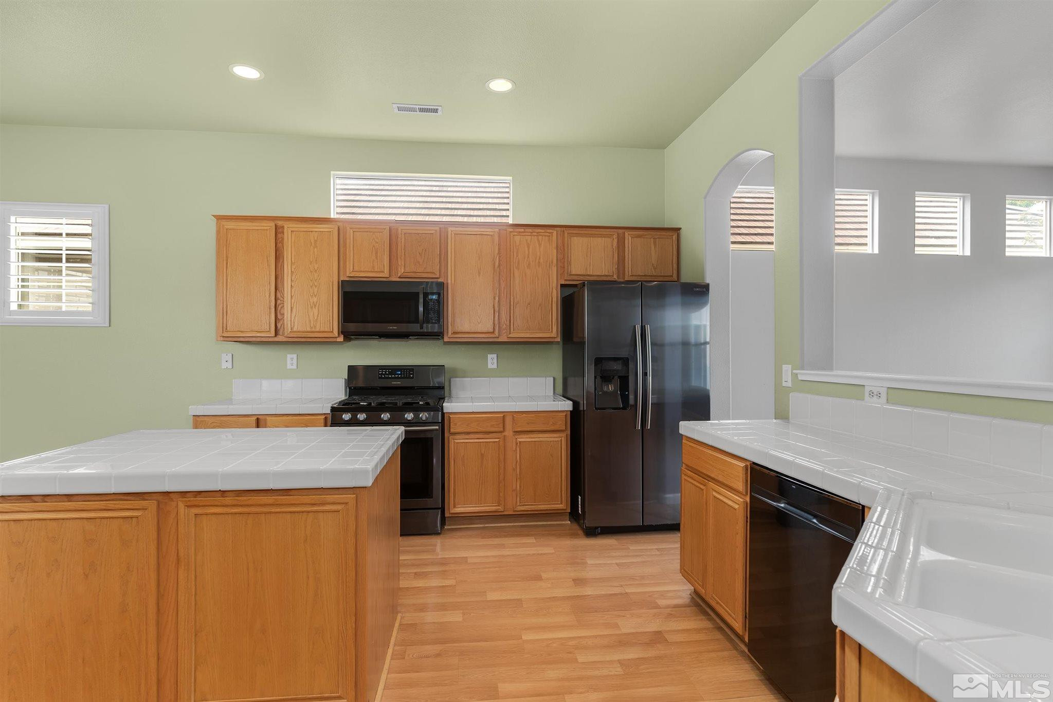 9649 Shadowstone Way Reno, NV 89521 - Photo 8 of 20 a kitchen with granite countertop stainless steel appliances and wooden cabinets