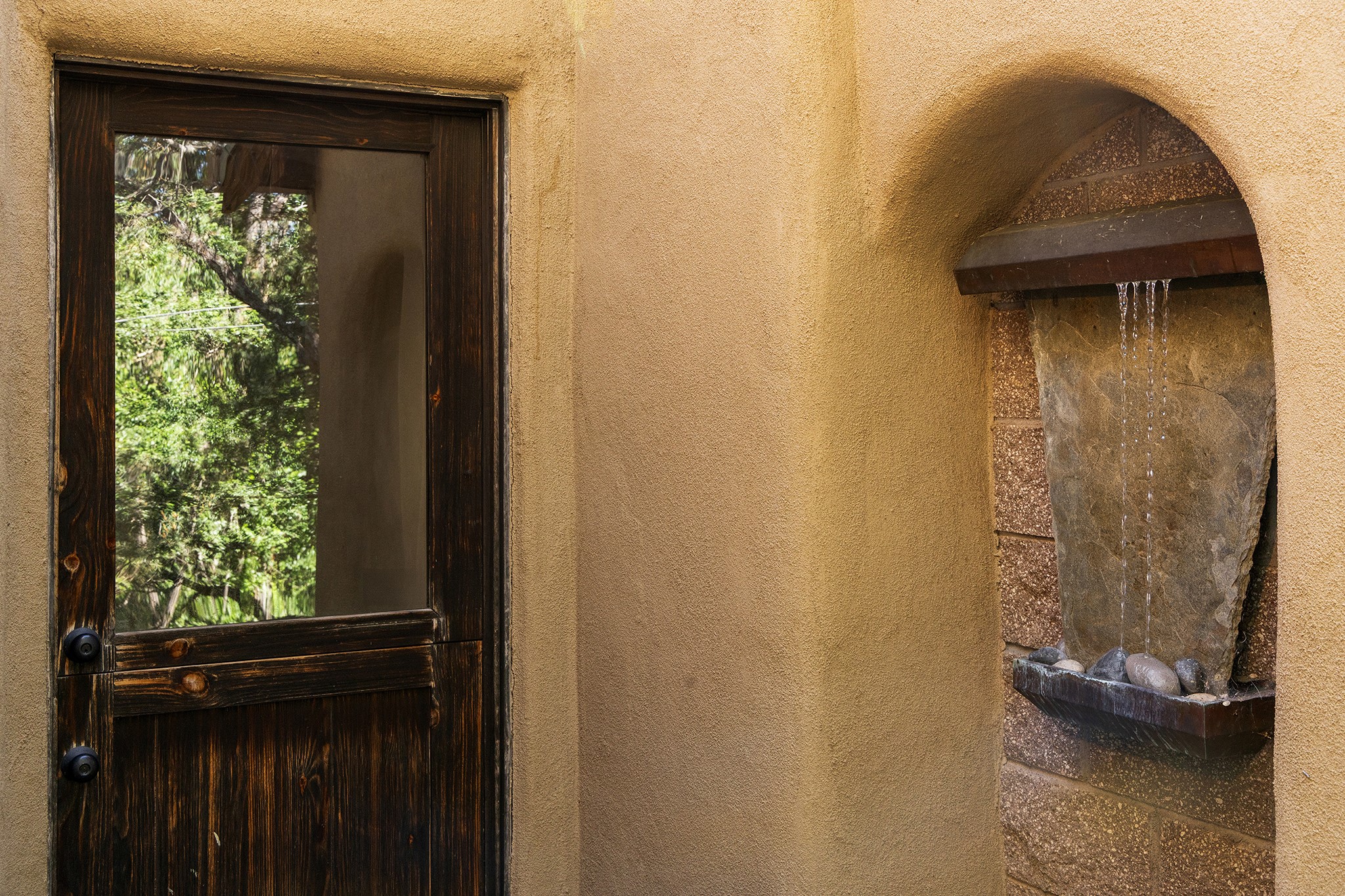 1330 Bishops Lodge Road Santa Fe, NM 87506 - Photo 22 of 54 Exterior door to Living Room 2 (wall water feature)