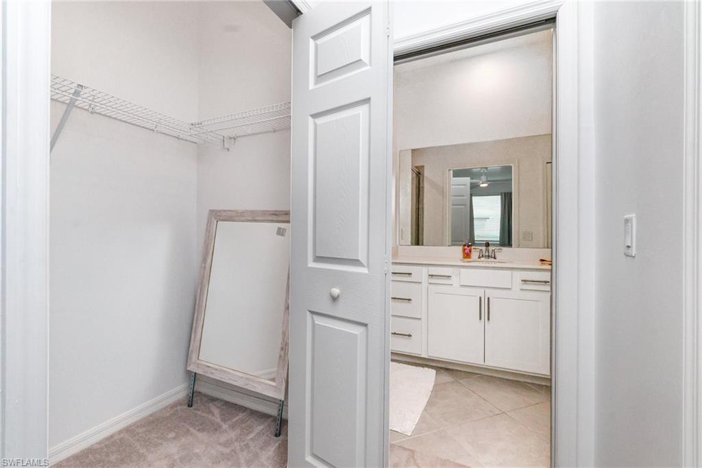 43989 Boardwalk Loop, Unit 2043 Babcock Ranch, FL 33982 - Photo 20 of 45 a bathroom with a granite countertop sink mirror and vanity