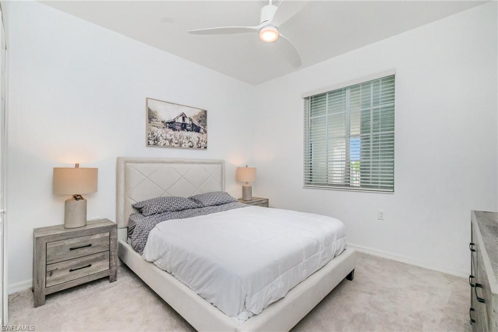 43989 Boardwalk Loop, Unit 2043 Babcock Ranch, FL 33982 - Photo 23 of 45 a bedroom with a large bed and a window