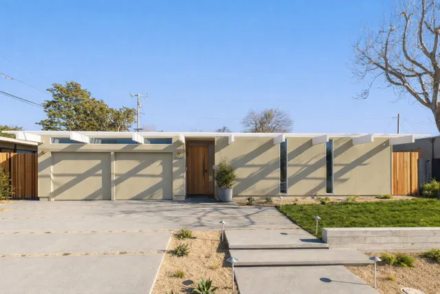 a kitchen with granite countertop a sink and a stove top oven