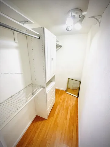 a kitchen with stainless steel appliances granite countertop a refrigerator a stove a sink with white countertops and cabinets