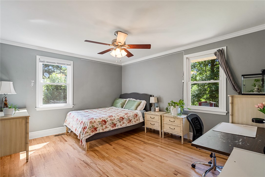 512 East Fredericks Street Anderson, SC 29621 - Photo 18 of 31 Hardwood floors and generous windows elevate this comfortable bedroom space.