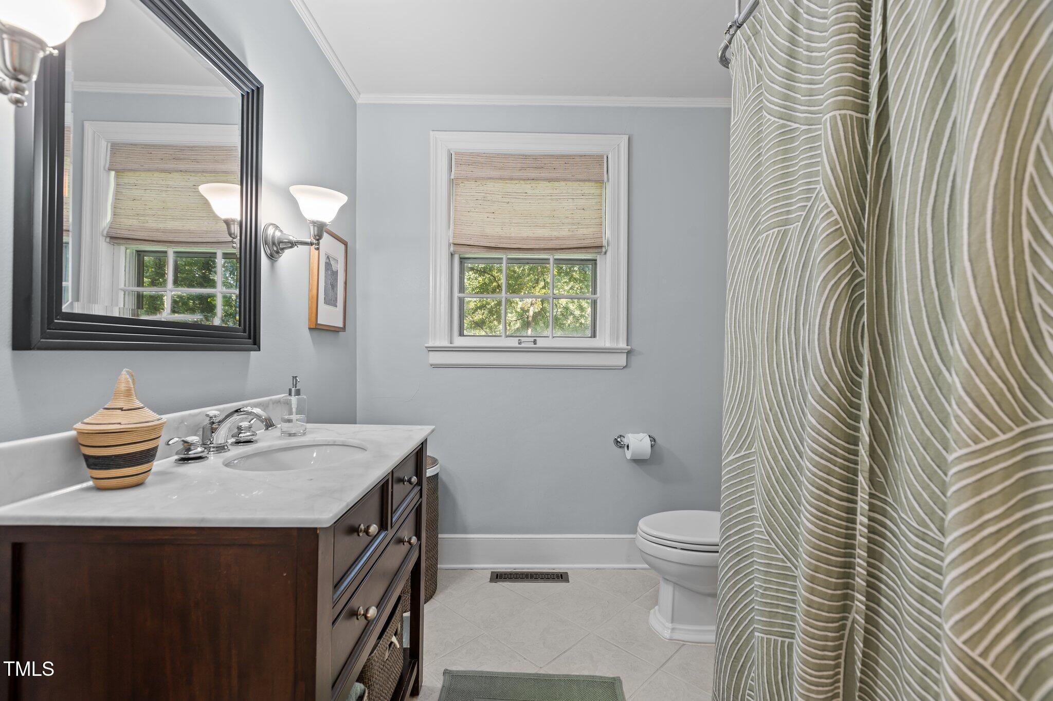 2706 Stuart Drive Durham, NC 27707 - Photo 19 of 26 a bathroom with a sink a toilet and shower curtain