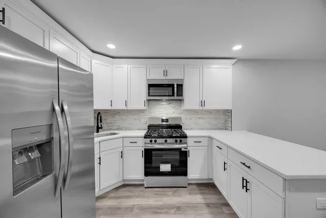 a view of kitchen with sink and window