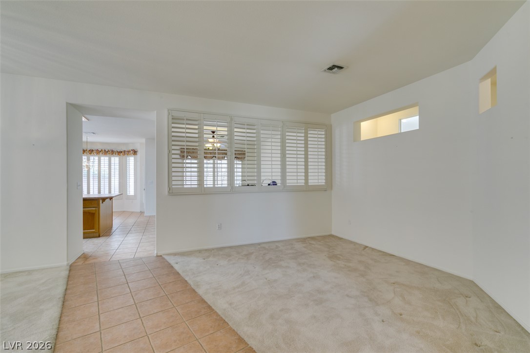 2189 Chapman Ranch Drive Henderson, NV 89012 - Photo 56 of 60 An open floor plan connects the carpeted living space to the adjacent tiled walkway.