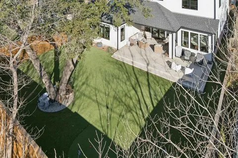 an aerial view of residential building with green space