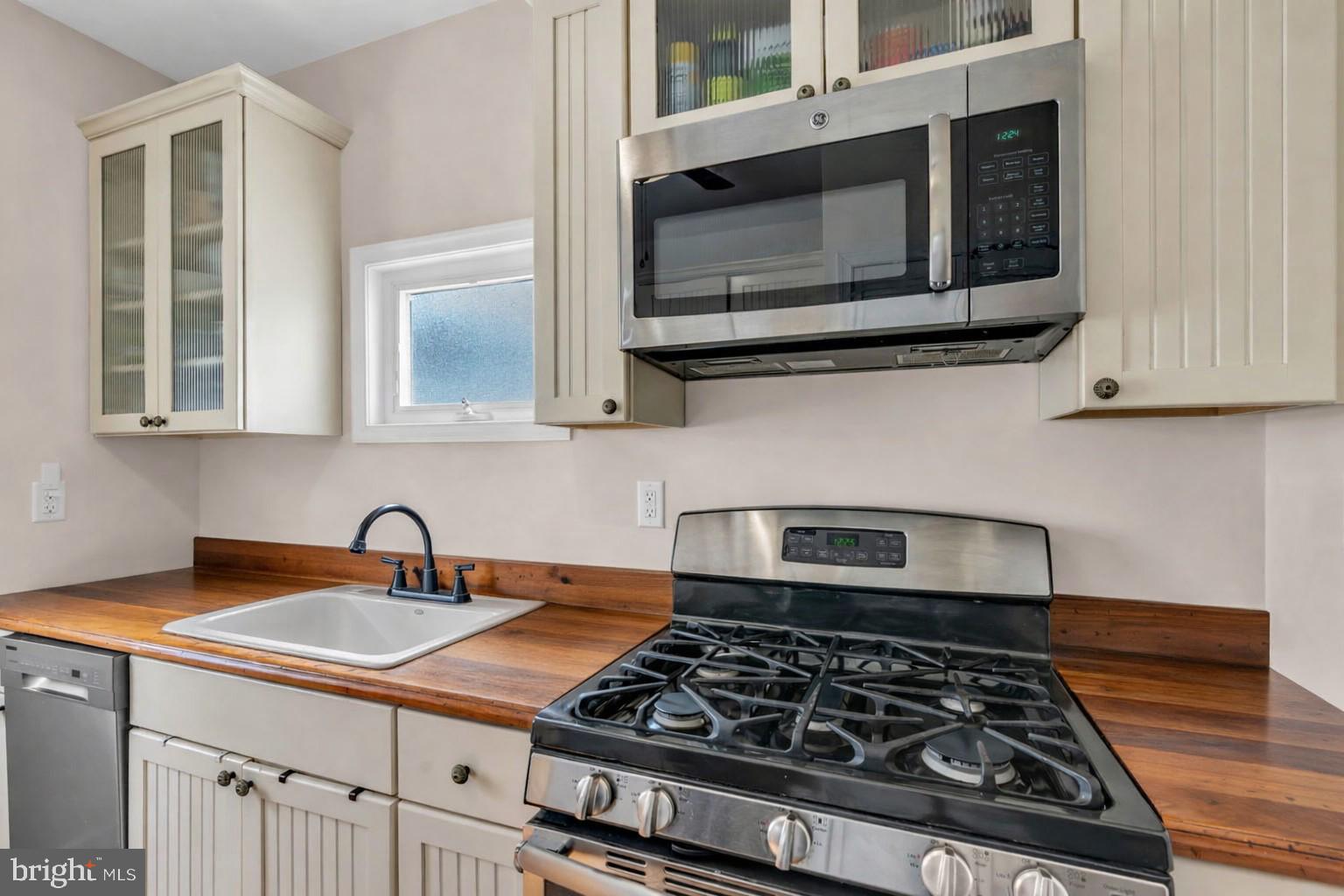 6 Beach Street Sea Bright, NJ 07760 - Photo 13 of 26 a kitchen with stainless steel appliances granite countertop a stove and a microwave