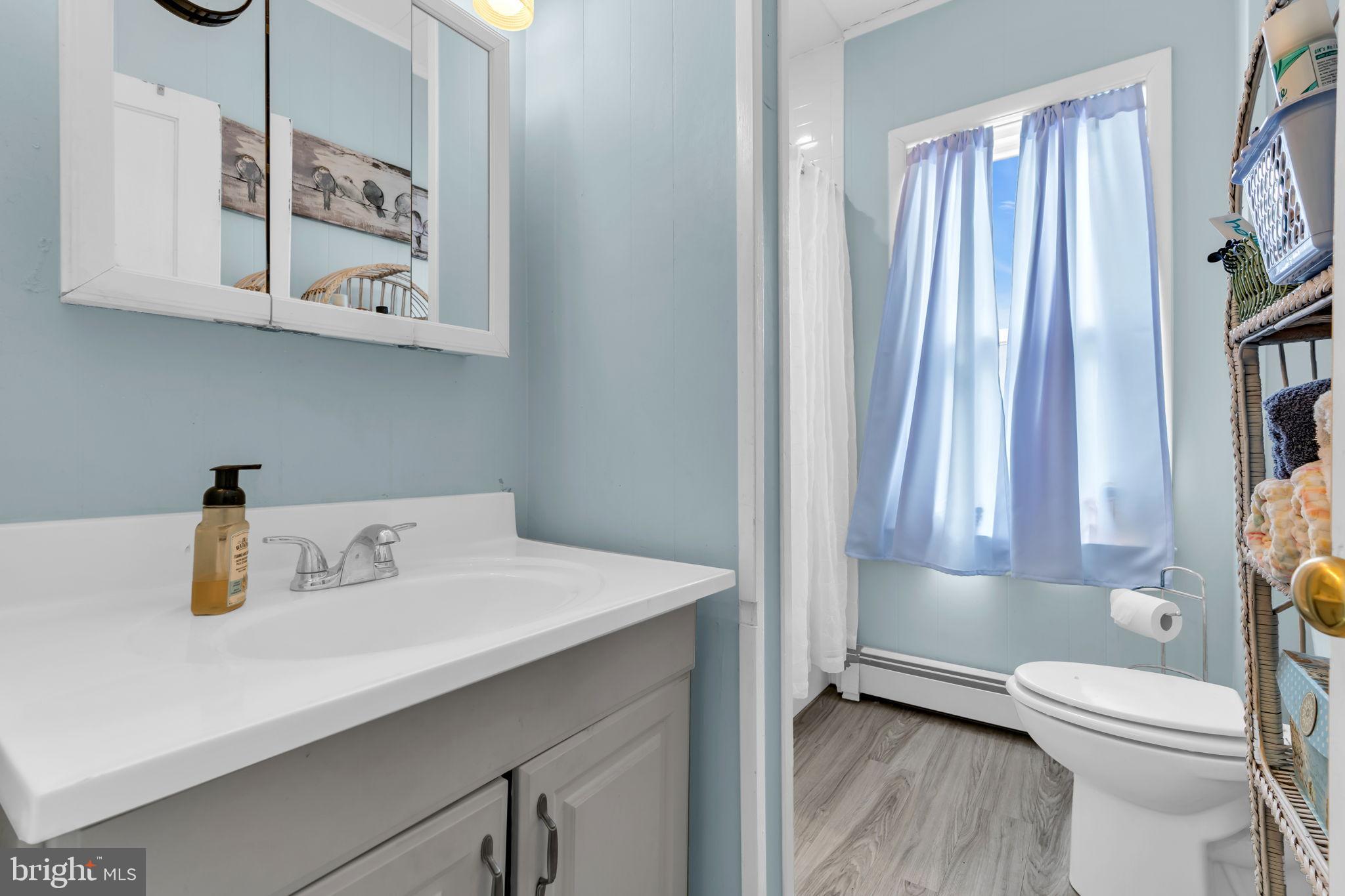 6 Beach Street Sea Bright, NJ 07760 - Photo 18 of 26 a bathroom with a sink a toilet and a window