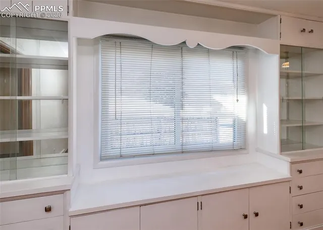 a view of wooden floor and windows in a room