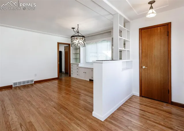 wooden floor in an empty room with a window