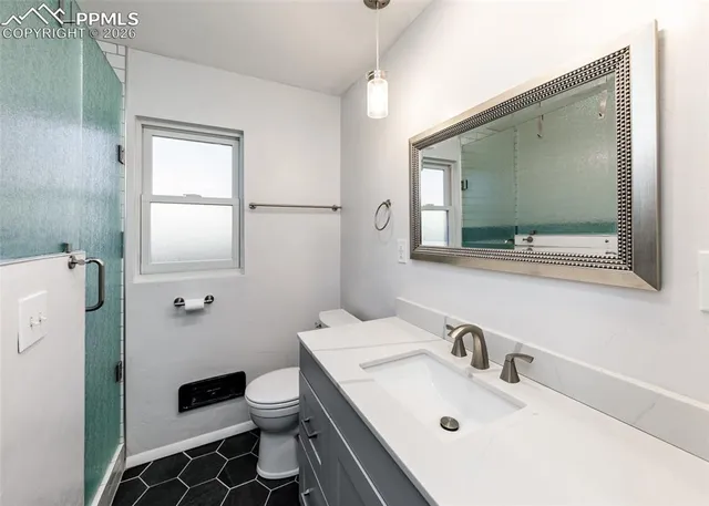 a bathroom with a sink toilet and mirror