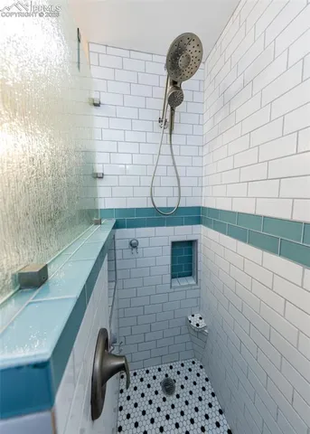 a bathroom with a black white checkered floor