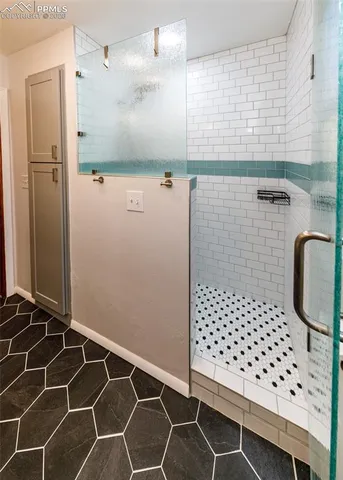 a view of a hallway with wooden floor and a livingroom