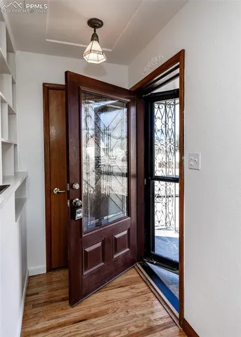a very nice looking room with a large window and wooden floor