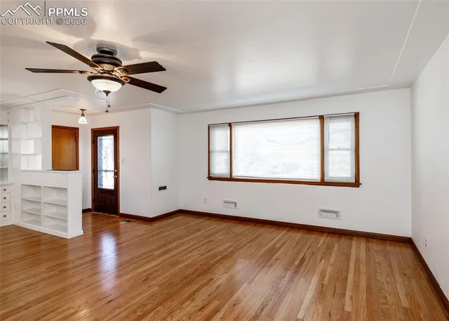 wooden floor in an empty room with a window