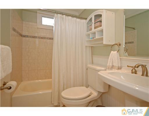 15 Hill Road Edison, NJ 08817 - Photo 11 of 13 a bathroom with a sink toilet and shower