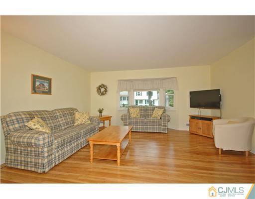 15 Hill Road Edison, NJ 08817 - Photo 3 of 13 a living room with furniture and a flat screen tv