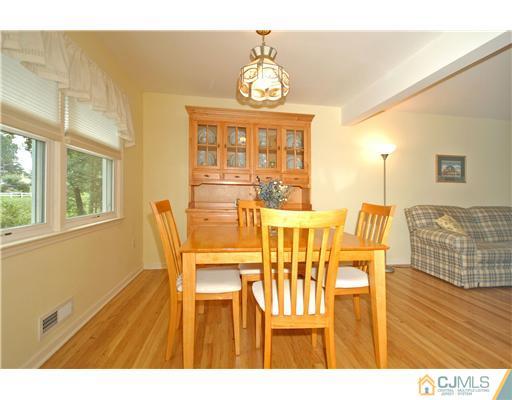 15 Hill Road Edison, NJ 08817 - Photo 4 of 13 a view of a dining room with furniture and a chandelier