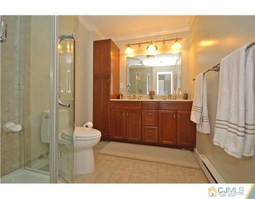 15 Hill Road Edison, NJ 08817 - Photo 8 of 13 a bathroom with a sink a toilet and shower