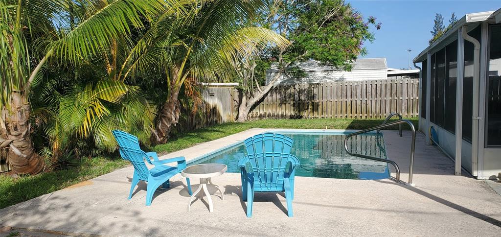 a view of backyard with deck and outdoor seating