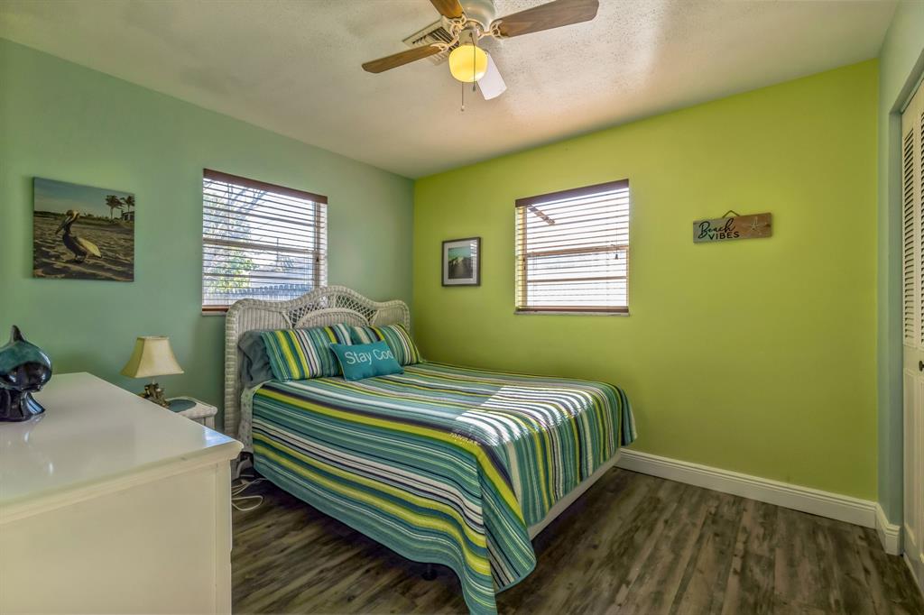 1153 Southeast Dolphin Drive Stuart, FL 34996 - Photo 17 of 31 a bedroom with a bed and a window