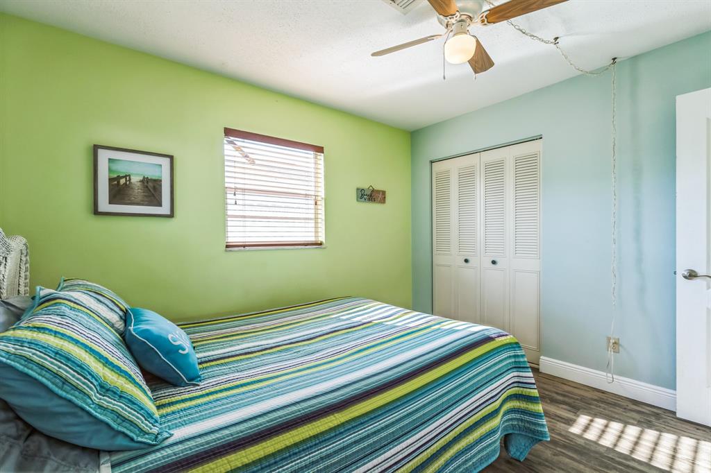1153 Southeast Dolphin Drive Stuart, FL 34996 - Photo 18 of 31 a bedroom with a bed and a window