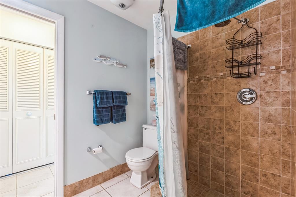 1153 Southeast Dolphin Drive Stuart, FL 34996 - Photo 20 of 31 a bathroom with a toilet and a shower