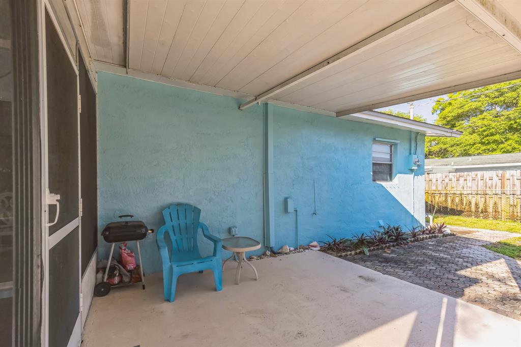 1153 Southeast Dolphin Drive Stuart, FL 34996 - Photo 23 of 31 a backyard of a house with table and chairs