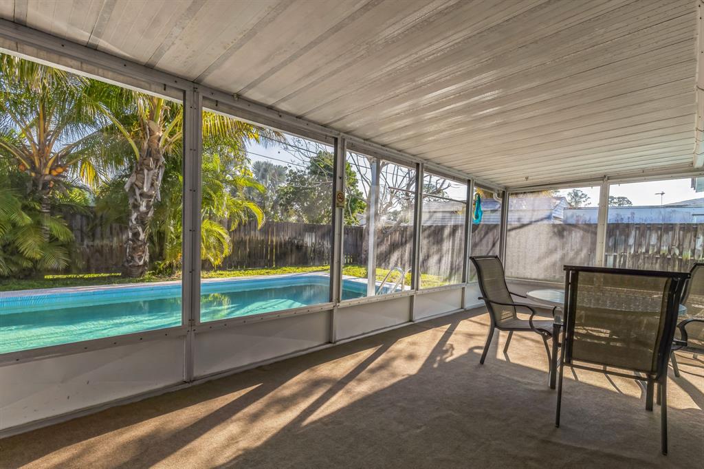 1153 Southeast Dolphin Drive Stuart, FL 34996 - Photo 26 of 31 a view of a porch with furniture and a yard