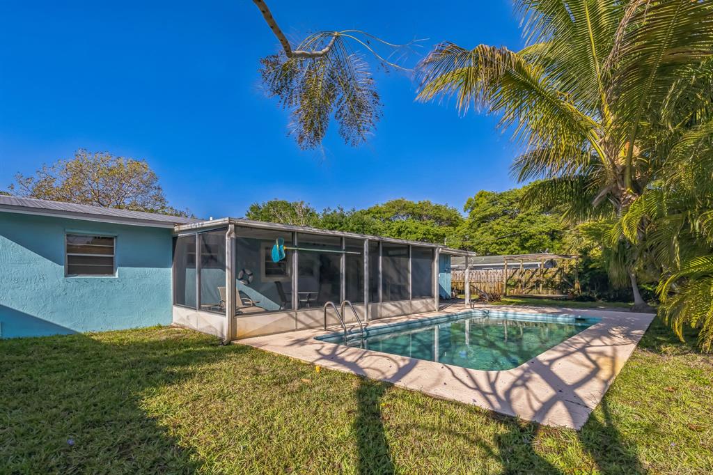1153 Southeast Dolphin Drive Stuart, FL 34996 - Photo 30 of 31 a view of a house with backyard porch and sitting area
