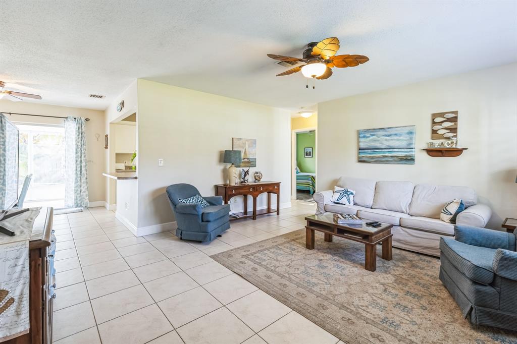 1153 Southeast Dolphin Drive Stuart, FL 34996 - Photo 5 of 31 a living room with furniture and a chandelier