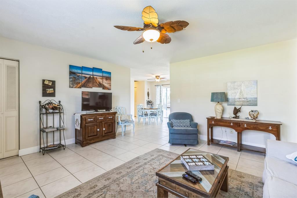 1153 Southeast Dolphin Drive Stuart, FL 34996 - Photo 7 of 31 a living room with furniture and a flat screen tv