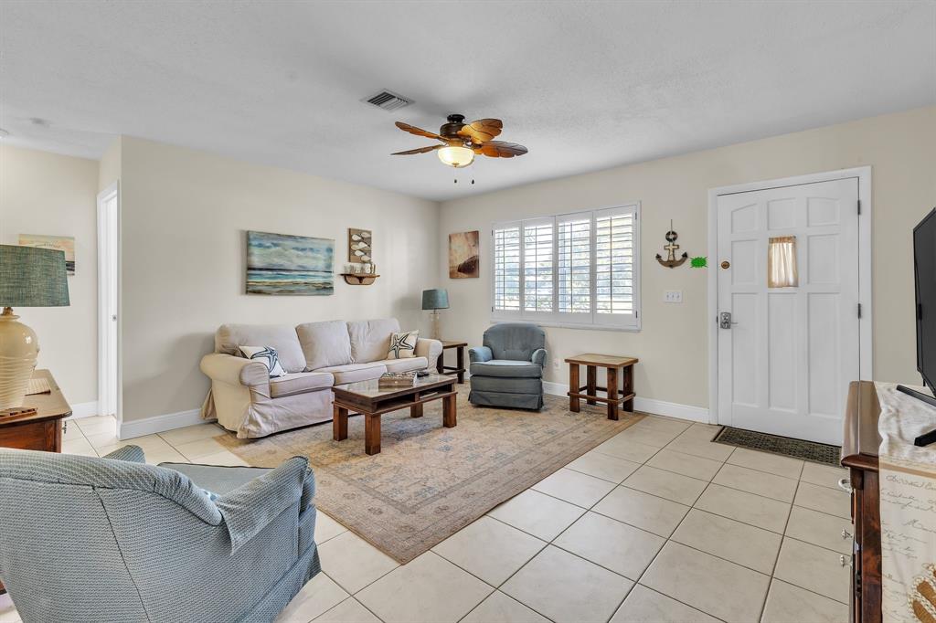 1153 Southeast Dolphin Drive Stuart, FL 34996 - Photo 8 of 31 a living room with furniture and a dining table