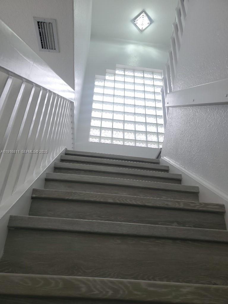 14765 Southwest 132nd Place Miami, FL 33186 - Photo 11 of 48 a view of entryway and hall with wooden floor