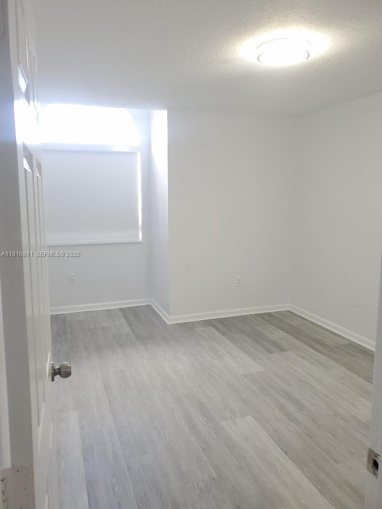 14765 Southwest 132nd Place Miami, FL 33186 - Photo 14 of 48 an empty room with a window