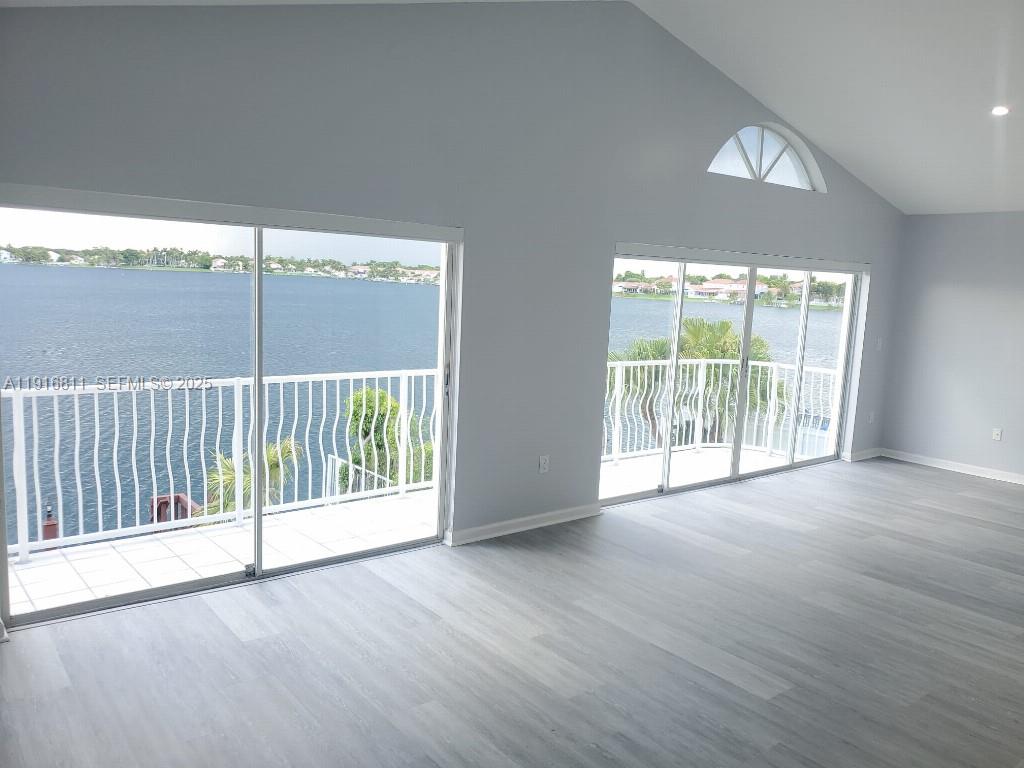 14765 Southwest 132nd Place Miami, FL 33186 - Photo 16 of 48 an empty room with wooden floor and windows