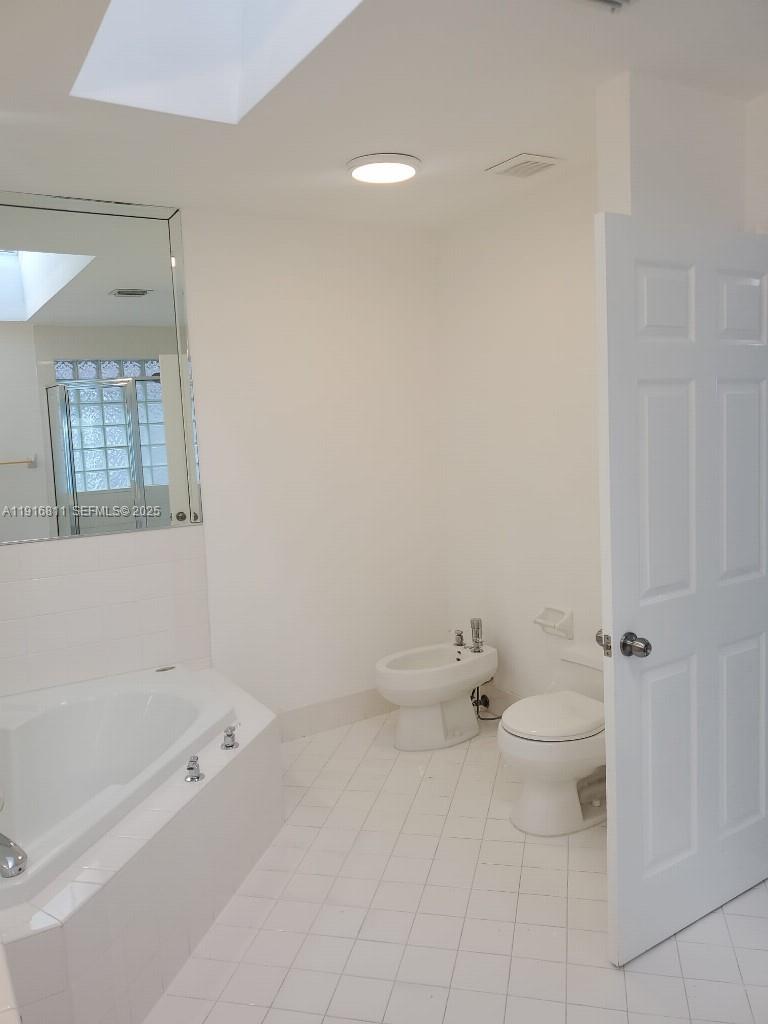 14765 Southwest 132nd Place Miami, FL 33186 - Photo 21 of 48 a bathroom with a toilet and a bathtub
