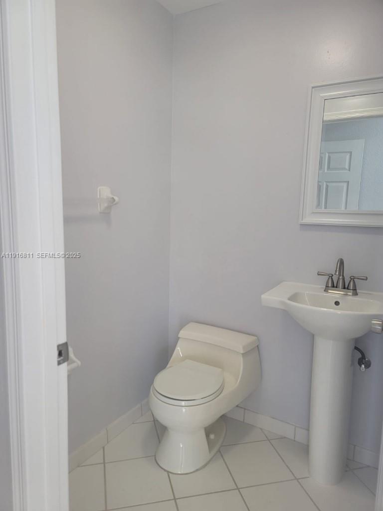 14765 Southwest 132nd Place Miami, FL 33186 - Photo 30 of 48 a bathroom with a toilet a sink and mirror