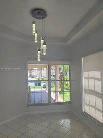 a kitchen with white cabinets a sink and appliances