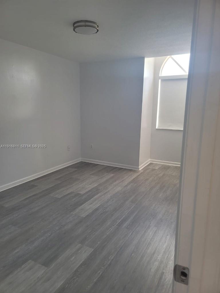 14765 Southwest 132nd Place Miami, FL 33186 - Photo 39 of 48 wooden floor in an empty room