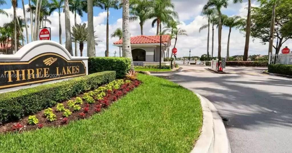 14765 Southwest 132nd Place Miami, FL 33186 - Photo 46 of 48 a front view of multi story residential apartment building with yard and sign board