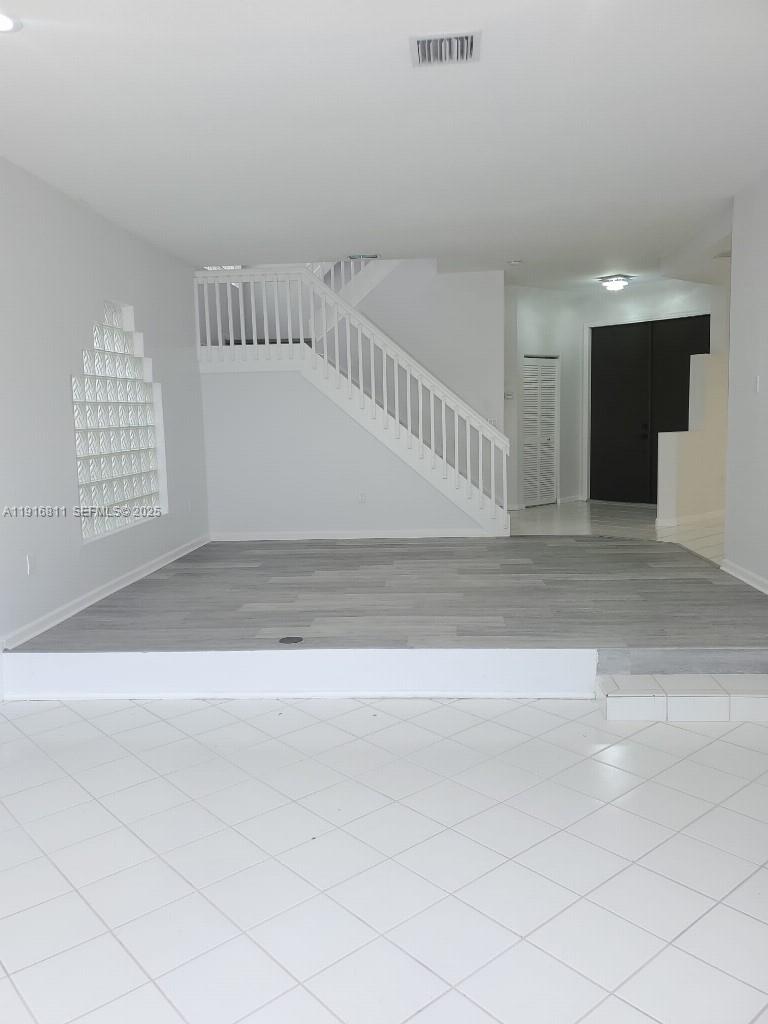 14765 Southwest 132nd Place Miami, FL 33186 - Photo 7 of 48 a view of staircase with white walls and windows