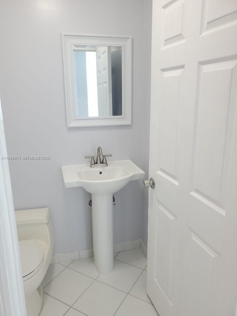 14765 Southwest 132nd Place Miami, FL 33186 - Photo 9 of 48 a bathroom with a sink toilet and a mirror