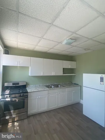 a kitchen with a sink and a stove top oven